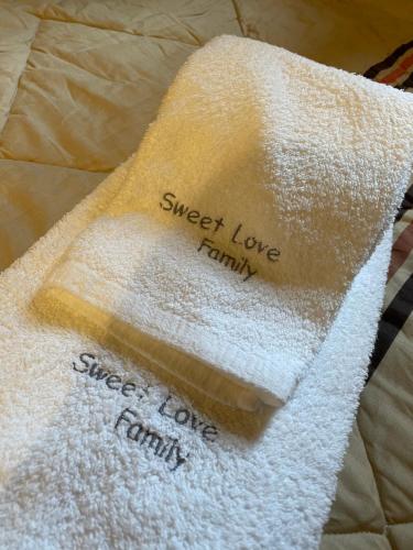 a towel with the words sweet love family on it at Sweet Love Family III in Coimbra