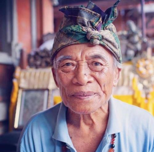 an older woman with a hat on her head at Liyer Spirit House in Ubud