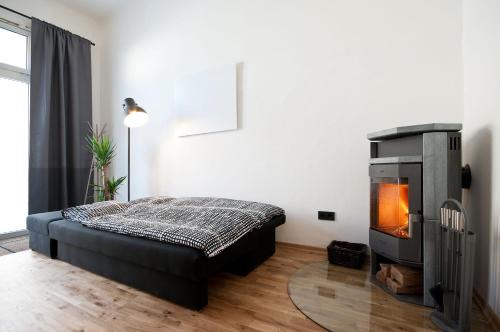 a bedroom with a bed and a fireplace at Zentrales & modernes City-Apartment in Graz