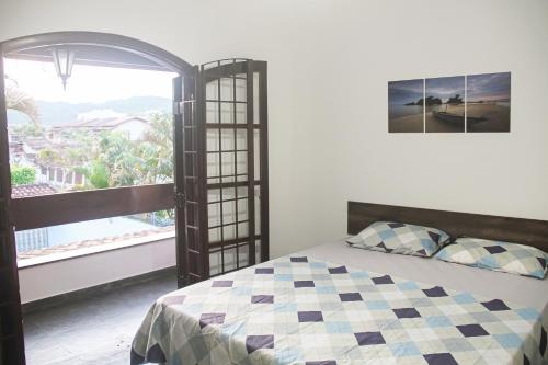 Ένα ή περισσότερα κρεβάτια σε δωμάτιο στο MarLua Quartos & Suítes