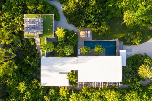 an overhead view of a house with a pool and trees at Villa Islander in Providenciales