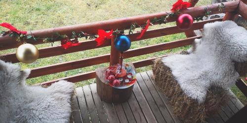a group of three sheep with christmas decorations on a fence at Holiday Home Captain's Village in Šljivovica