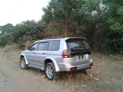 a silver truck parked on the side of a dirt road at Remarkable 4-Bed with air conditioning in Brikama in Brikama