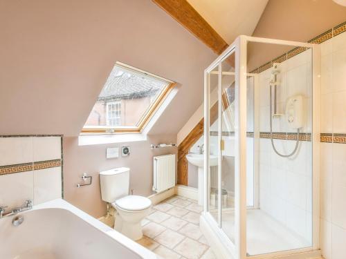 a bathroom with a toilet and a tub and a sink at Lady Pond Retreat in Ashbourne