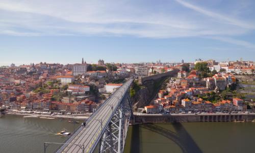 a bridge over a river with a train on it at Majestic Hostel Porto in Porto
