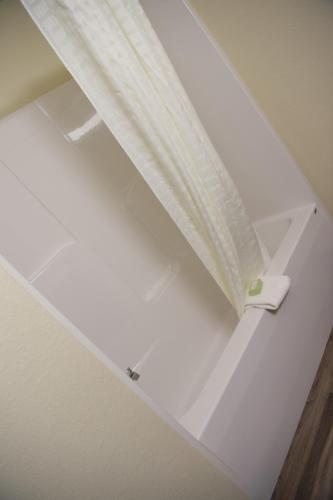 a white ceiling with a curtain on it at Cobblestone Inn & Suites - Forest City in Forest City