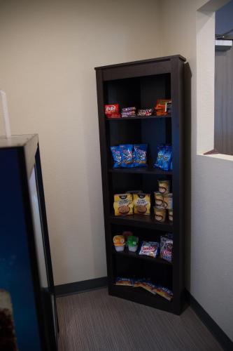 a shelf full of food in a room at Cobblestone Inn & Suites - Forest City in Forest City
