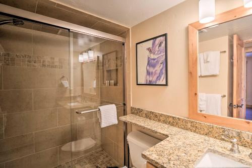 a bathroom with a shower and a toilet and a sink at Ski-In Breck Condo Walk to Shops and Restaurants! in Breckenridge