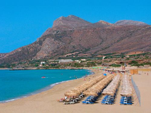 een strand met een stel stoelen en de oceaan bij Villa Smaragdi - Private Sea View Villa in Falasarna