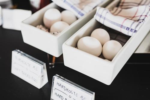 three boxes of eggs on a table with signs at Hotel Atlantic in Aarhus