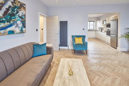a living room with a couch and a table at Host & Stay - Bellevue Apartments in Redcar