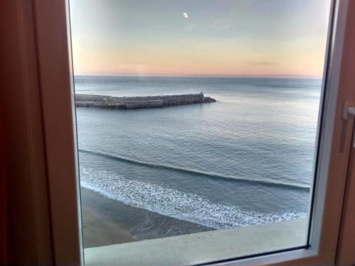a view of the ocean from a window at Arrigorri Ostatu Jatetxea in Ondárroa