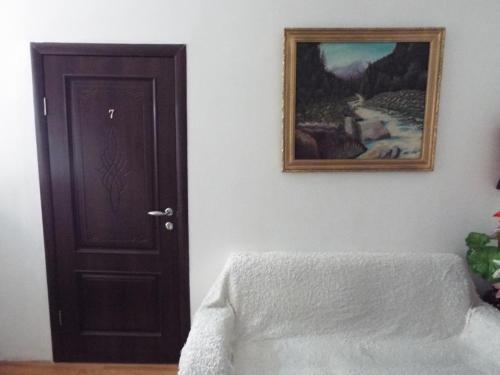 a room with a door and a picture on the wall at Ulpan Mini Hotel in Astana