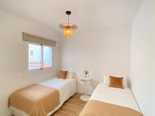 מיטה או מיטות בחדר ב-Apartamentos palangreros