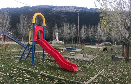 a playground with a slide in a park at Chalet in the Forest in Kalavrita