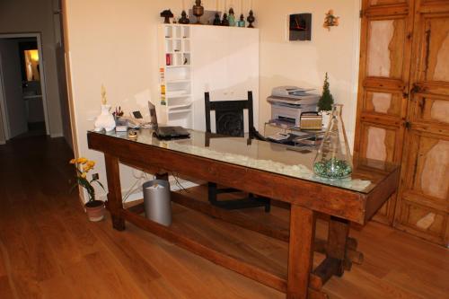 a wooden desk in a room with a fireplace at Dimora di Charme Cassaro 168 in Marsala