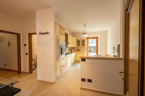 a kitchen with yellow cabinets and a counter top at SEVEN ALDO FLAT in Ponte Caffaro