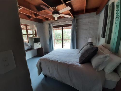 a bedroom with a bed and a ceiling fan at Rock Cottage, Bela-Bela in Bela-Bela
