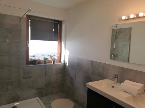 a bathroom with a sink and a toilet and a window at Haus Barbara in Forstau