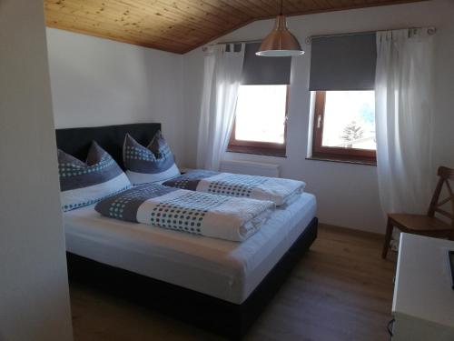 a bedroom with a bed with blue pillows at Haus Barbara in Forstau