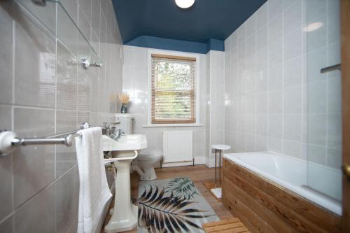 Un baño con lavabo, bañera e inodoro. en The Victorian Getaway - Central, en Canterbury