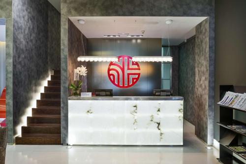 a lobby of a store with a red logo at NH Collection Lisboa Liberdade in Lisbon