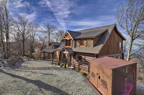 a house with a fence in front of it at 1 Mi to Beech Mtn Cabin with Fire Pit and BBQ! in Beech Mountain