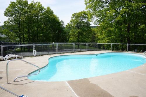 a large swimming pool with a metal fence around it at 37 Partridge Woods in Bartlett