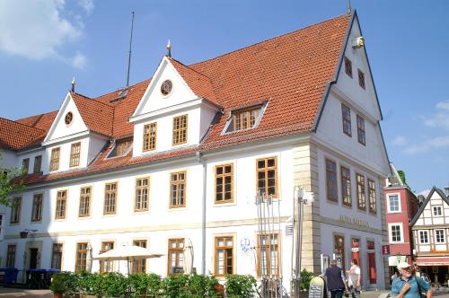 a large white building with a red roof at Hotel TraumzeitHof in Eschede