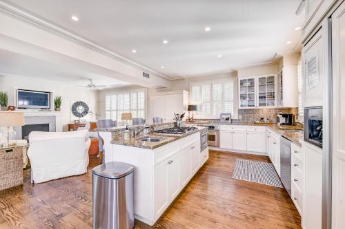a kitchen with white cabinets and a large island at Camellia Villa in Saint Simons Island