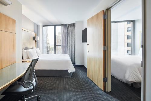 a hotel room with a bed and a desk at Club Quarters Hotel World Trade Center, New York in New York