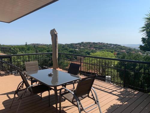 a patio with a table and chairs on a deck at Bokamoso Views in Rustenburg