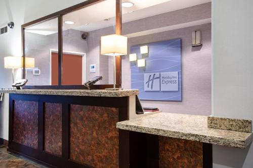 a bathroom with a sink and a mirror at Holiday Inn Express Hotel & Suites Littleton, an IHG Hotel in Littleton