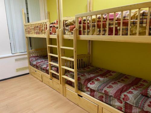 twolevel bunk beds in a room with wooden floors at Хостел Мажор in Kharkiv