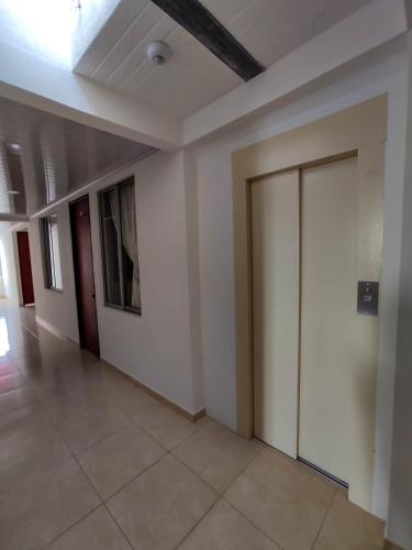 an empty hallway with a door in a building at Hotel Central Fusa in Fusagasuga