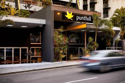 a car driving in front of a building with a pumpkin sign at Punthill Spring Hill in Brisbane