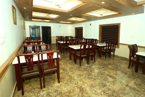 a dining room with wooden tables and chairs at CeeCee Grand Resort in Vagamon