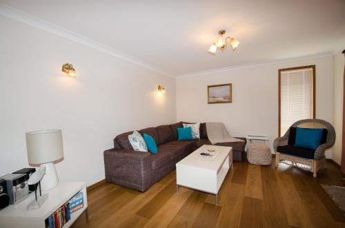 a living room with a couch and a table at Kiama Coastal Escape in Kiama
