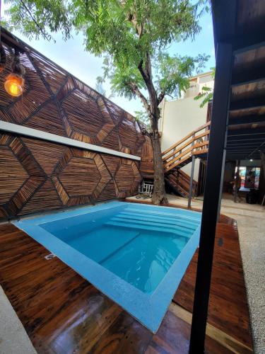 a swimming pool in the backyard of a house at Malakai Hostel in Tulum