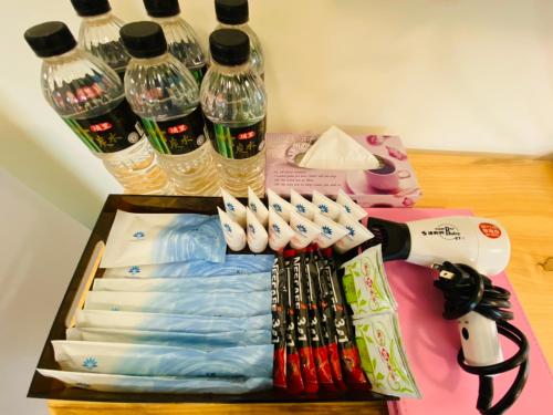 a table topped with bottles of water and toothbrushes at Taitung Crabs House in Chenggong