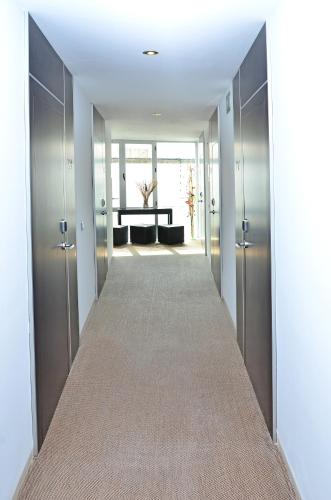 a hallway leading to a living room with a table at Hostal Campito in Conil de la Frontera