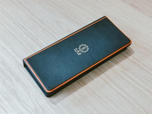 a notebook sitting on top of a wooden table at Shanghai Fish Inn People Square in Shanghai