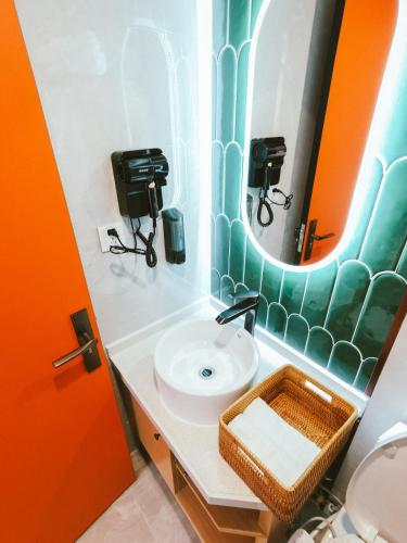a bathroom with a sink and a mirror at Shanghai Fish Inn People Square in Shanghai