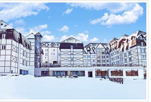a large building with snow in front of it at TeonaLux Kraljevi Cardaci 5a/22 in Kopaonik