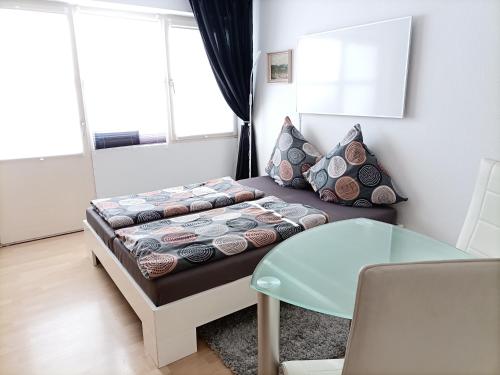 a small living room with a couch and a table at BodenSEE Apartment Kressbronn Fischerdorf SEE 1 in Kressbronn am Bodensee