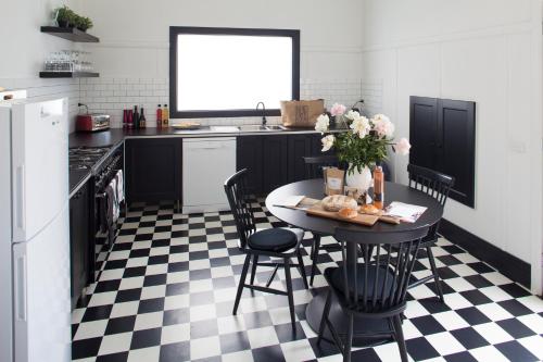 a kitchen with a black and white checkered floor at Domino House in Trentham