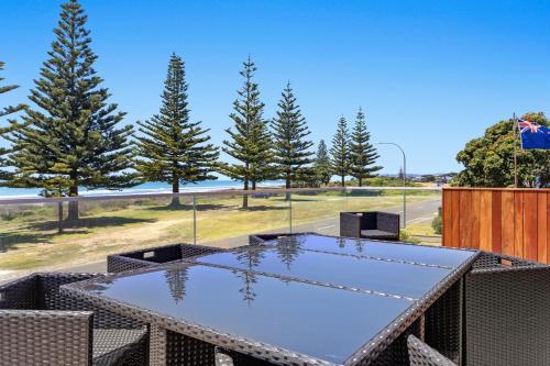 a ping pong table on a patio with trees at Ohope Beachside Retreat - Ohope Holiday Home in Ohope Beach