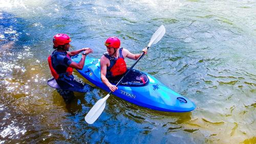 two people in a blue kayak in the water at Gopeng Campsite in Gopeng