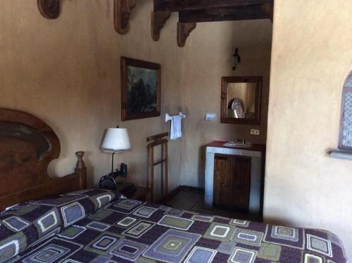 a bedroom with a bed and a sink in a room at Hosteria Covadonga in Perote