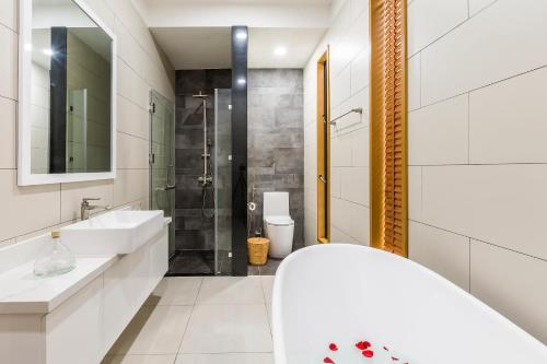 baño blanco con ducha y lavamanos en COASTAR SAKI HO TRAM en Xuyên Mộc